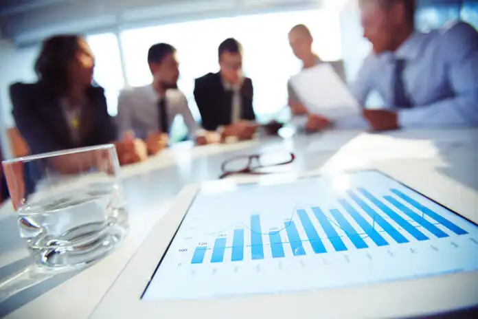 Close-up,Of,Touchpad,With,Graphics,On,The,Table,With,People