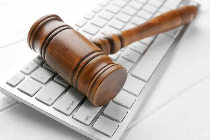 Wooden,Judge's,Gavel,On,Computer,Keyboard,,Closeup